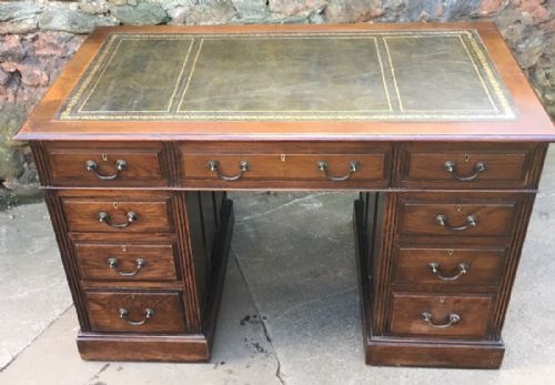 solid oak pedestal desk with green tooled leather insert