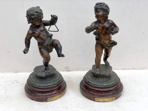 pair of spelter putti playing instruments