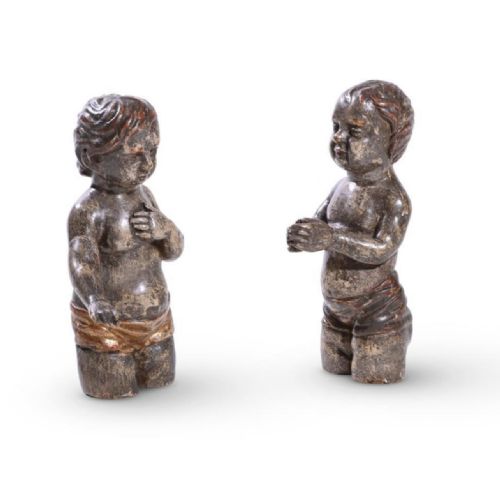 two similar polychrome silvered carved cherubic figures