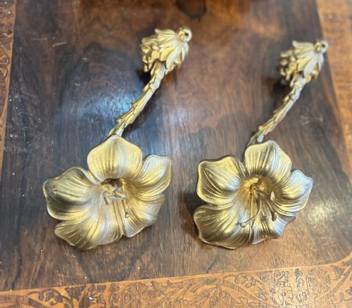 pair of giltbrass curtain tie backs withstylised flower head