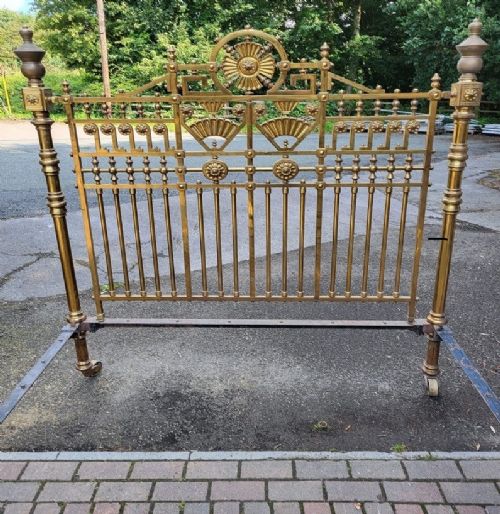 fig 1. An ornate Victorian brass king-size bedstead featuring geometric lattice panels, central rosette medallions, turned side posts, and decorative finials.