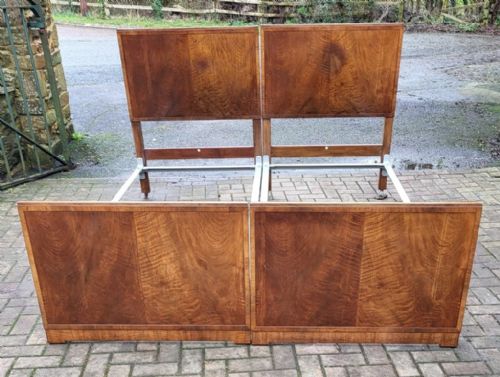 fig 1. A pair of matching Edwardian single bedsteads crafted from figured walnut with rectangular panelled headboards and footboards.
