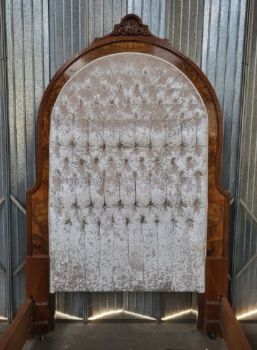 A Victorian double-sized bedstead featuring a high arched button-upholstered headboard framed in carved walnut and a matching footboard with burr walnut veneer panels. View II