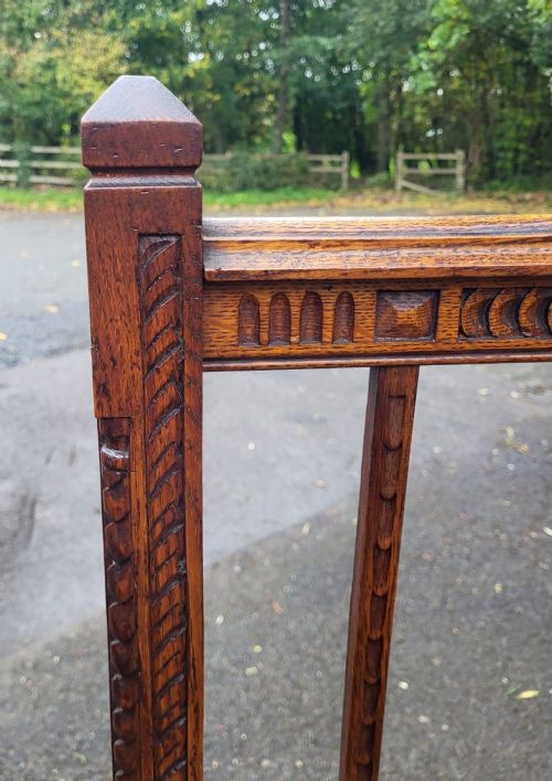 A late Victorian double-sized carved oak bedstead featuring a vertical slatted headboard and footboard with carved geometric friezes. View III