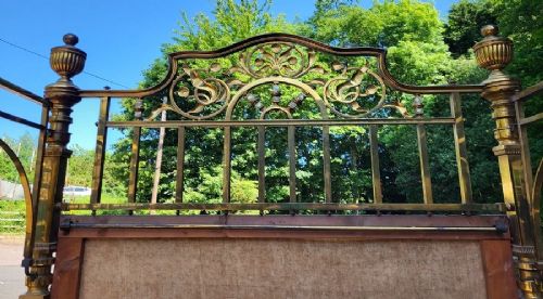 Victorian double size brass half tester bedstead featuring ornate floral cresting, urn finials, and reeded posts. View III