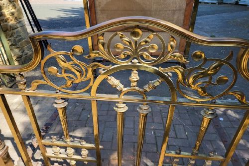 Victorian double size brass half tester bedstead featuring ornate floral cresting, urn finials, and reeded posts. View IV