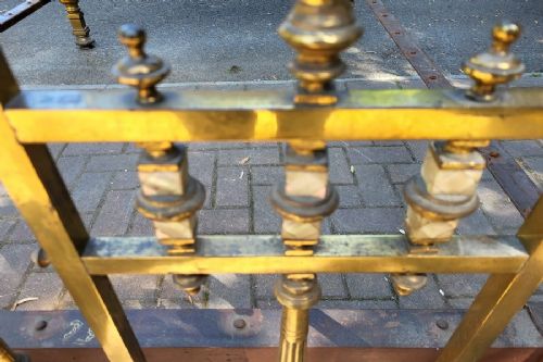 Victorian double size brass half tester bedstead featuring ornate floral cresting, urn finials, and reeded posts. View V