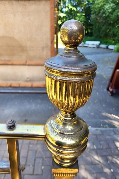 Victorian double size brass half tester bedstead featuring ornate floral cresting, urn finials, and reeded posts. View VI