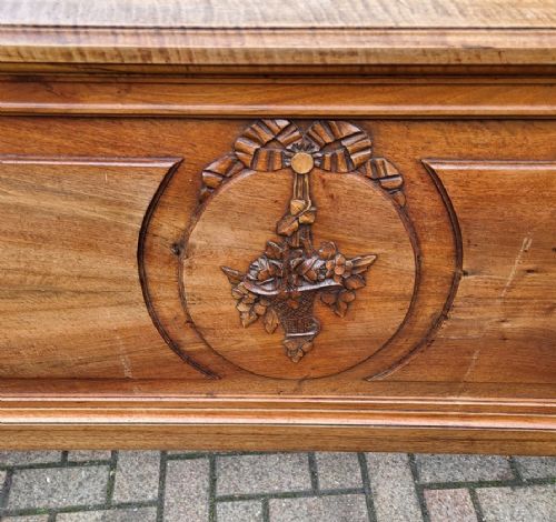 A late 19th-century French carved walnut bedstead featuring an arched cresting headboard and a decorative carved oval footboard panel. View II
