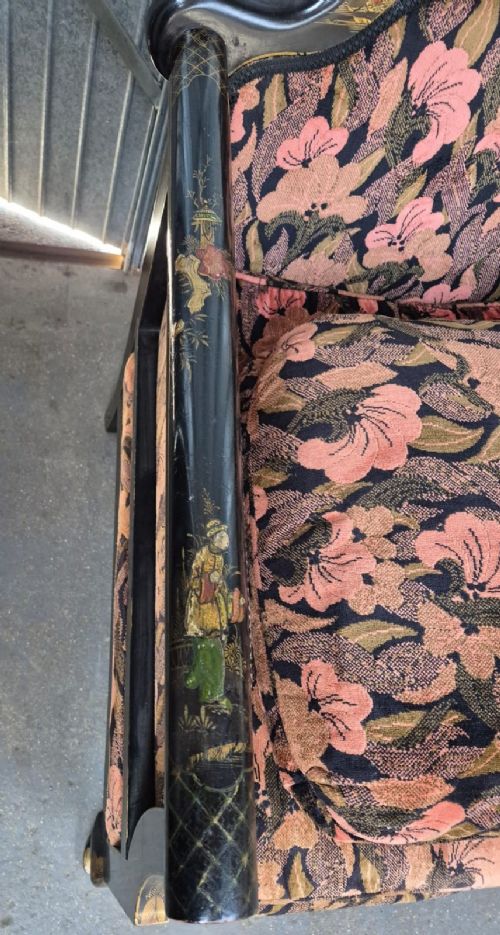 A three-piece Edwardian seating suite comprising a central two-seater settee and two matching armchairs with black lacquered frames adorned with gilded Chinoiserie patterns and pink floral pattern fabric upholstery. View IV