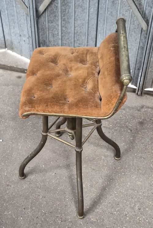 A Victorian brass-framed harpist stool with a buttoned warm brown velvet seat and splayed legs. View II
