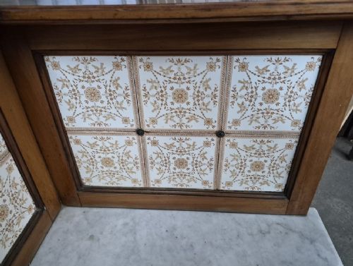 A Victorian walnut corner washstand featuring an upper corner splashback with patterned ceramic tiles, a white marble surface, and a two-door cabinet below. View II
