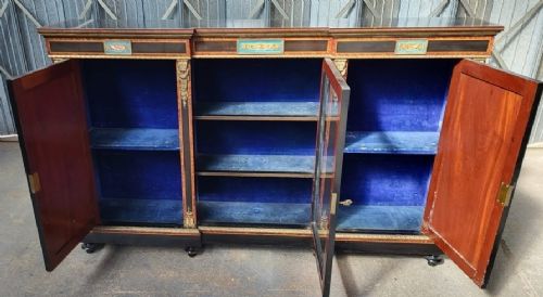 Victorian ebonised breakfront three-door side cabinet featuring gilt ormolu mounts, marquetry inlay, porcelain plaques, and a central glazed display section. View II