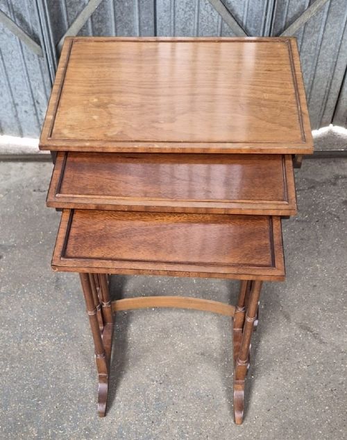 A set of three nested Edwardian mahogany side tables featuring rectangular tops with moulded edges and slender ring-turned legs. View II