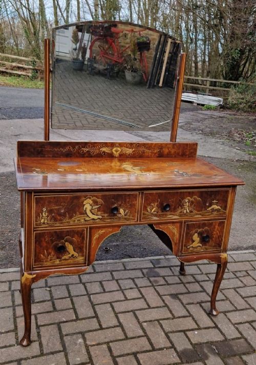 A four-piece Edwardian walnut bedroom suite featuring hand-painted Chinoiserie motifs, comprising a bedstead, wardrobe, dressing table, and chest of drawers with cabriole legs. View V