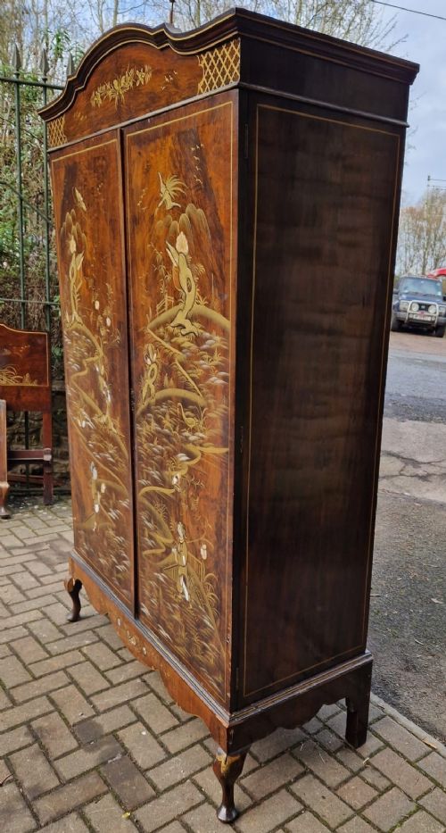 A four-piece Edwardian walnut bedroom suite featuring hand-painted Chinoiserie motifs, comprising a bedstead, wardrobe, dressing table, and chest of drawers with cabriole legs. View XI