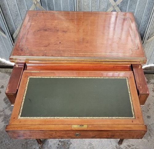 A 19th-century French walnut metamorphic side table featuring an inlaid rectangular fold-over top, brass hinges, a central drawer, and slender fluted tapered legs. View II