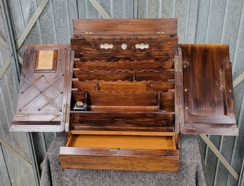 A Victorian oak slope-front desk box featuring twin doors with a central keyhole escutcheon and a polished timber finish. View II