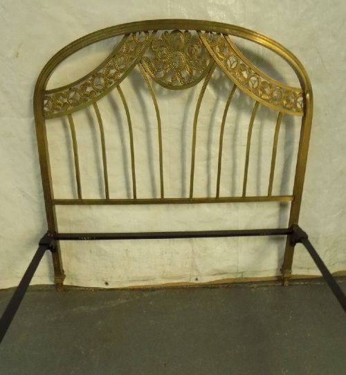 A late 19th-century brass bedstead with an arched headboard and footboard featuring detailed scrollwork and vertical spindles. View II