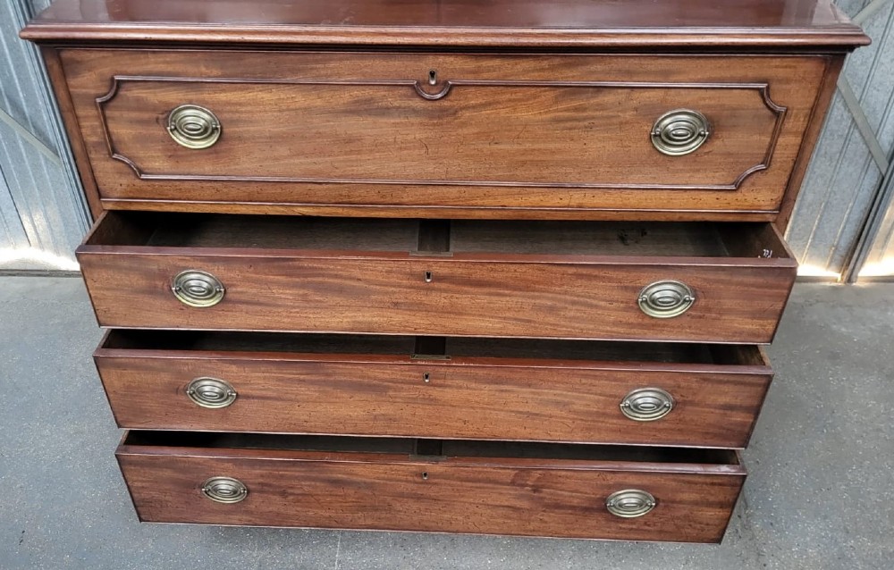 A Georgian mahogany secretaire bookcase featuring an upper cabinet with gothic astragal glazed doors above a lower chest of four drawers with brass handles. View III
