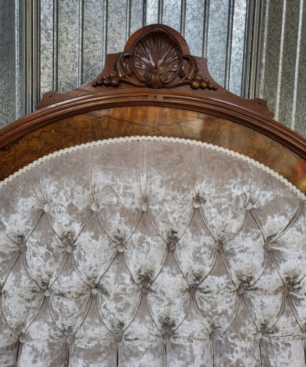A Victorian double-sized bedstead featuring a high arched button-upholstered headboard framed in carved walnut and a matching footboard with burr walnut veneer panels. View III