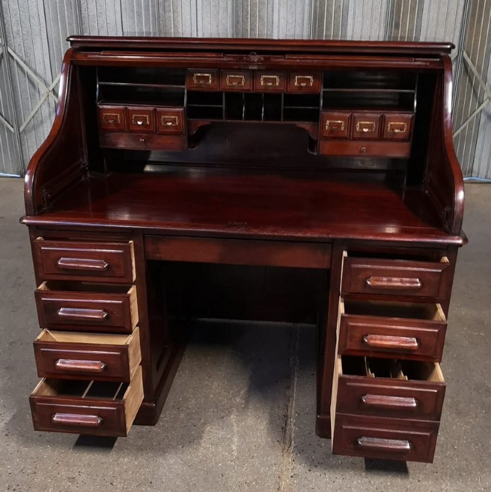 A Victorian mahogany roll top desk featuring a slatted tambour shutter above two pedestals of drawers. View III