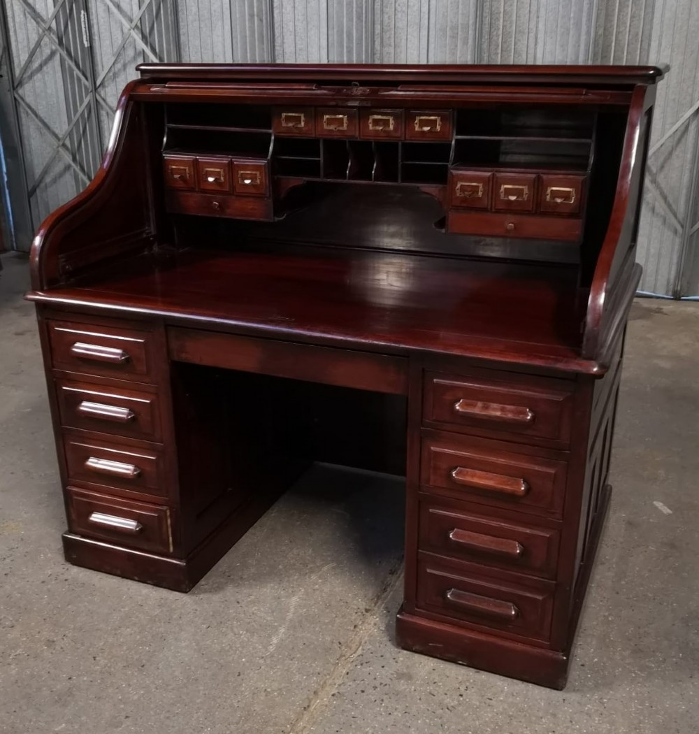 A Victorian mahogany roll top desk featuring a slatted tambour shutter above two pedestals of drawers. View IV