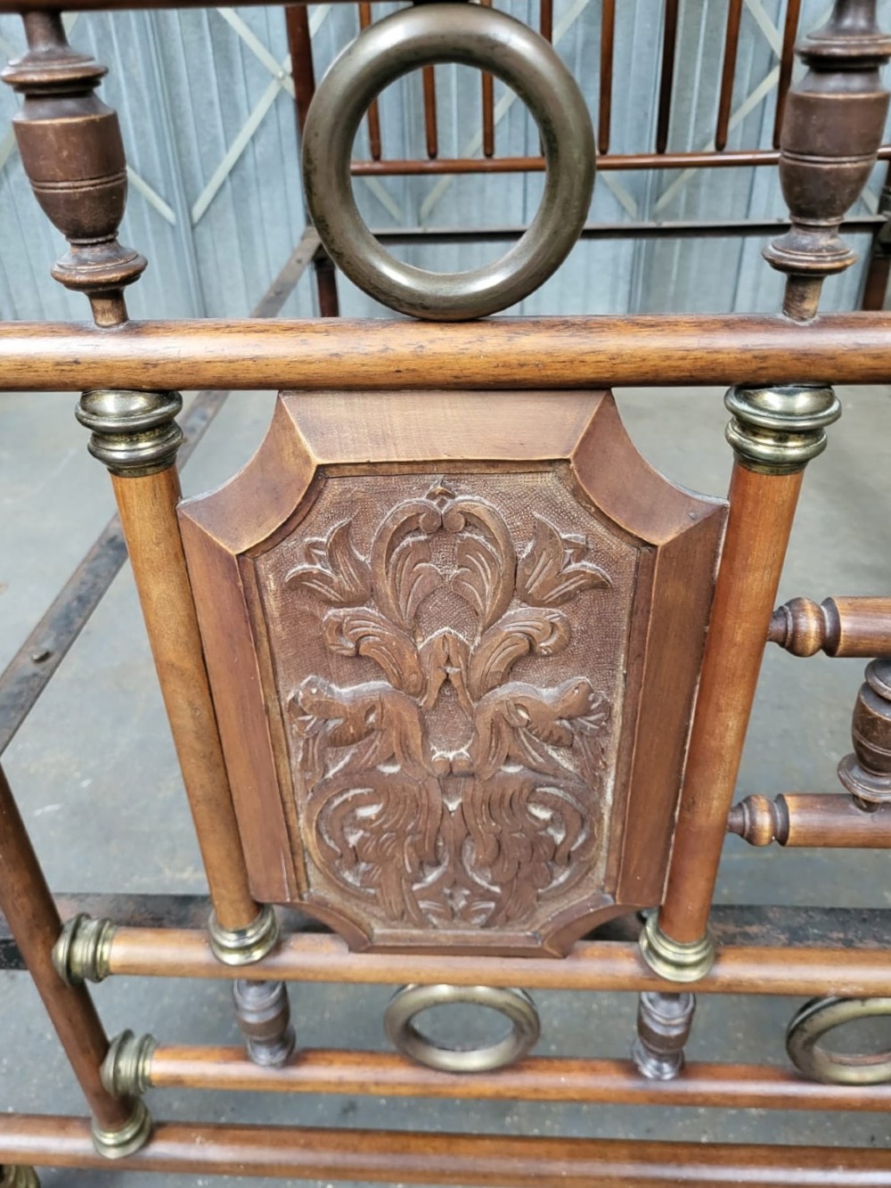 A Victorian double bedstead crafted from turned walnut timber featuring carved panels, decorative brass rings, and brass finials on the headboard and footboard. View III
