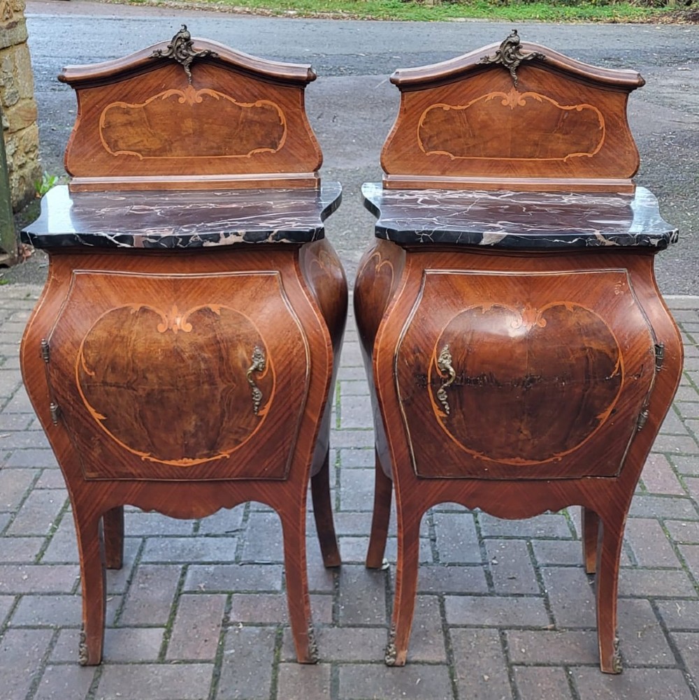 An Italian Rococo king-size walnut bedstead with serpentine contours and marquetry inlay, flanked by two matching marble-topped bombe bedside cabinets. View IV