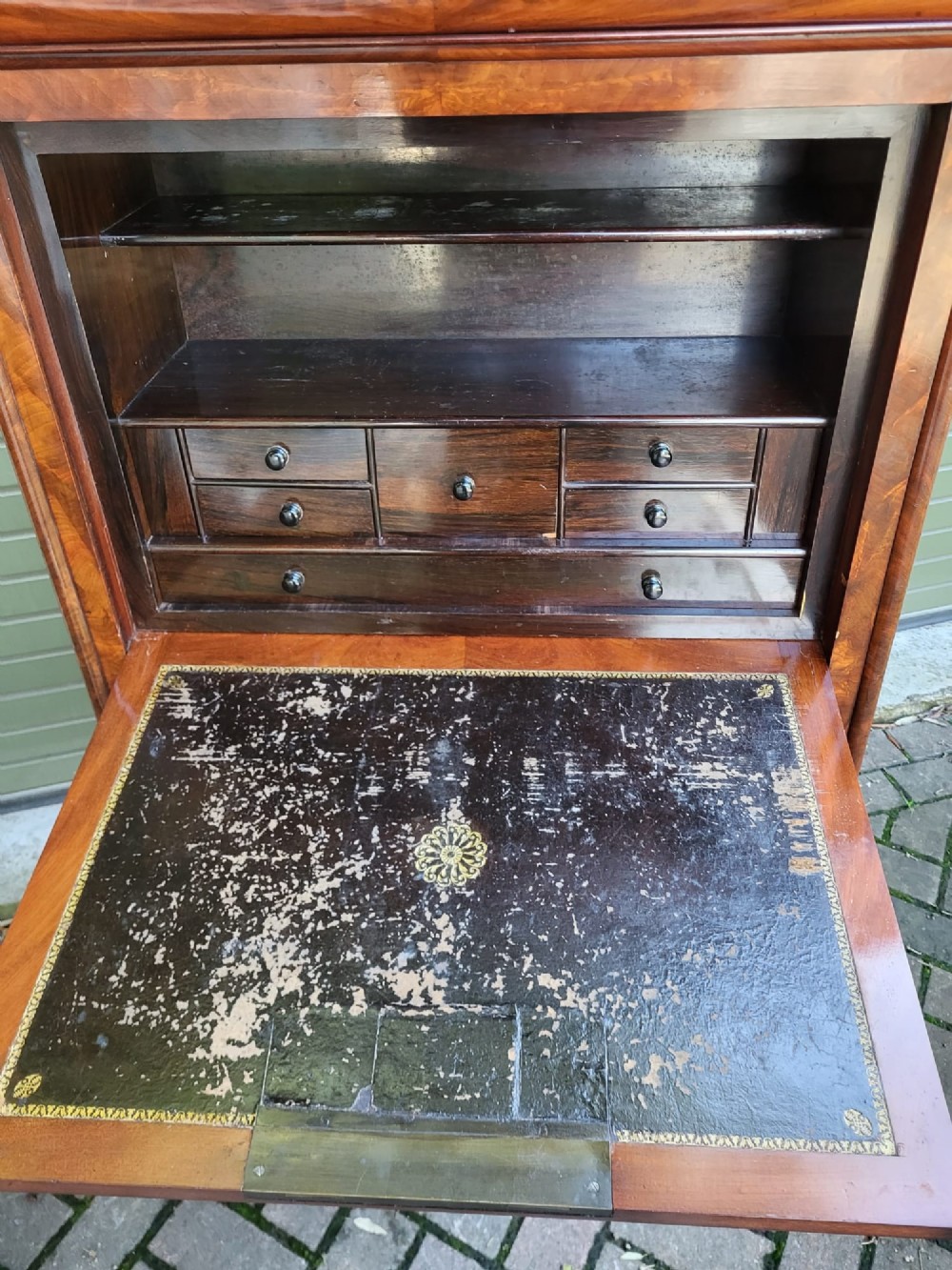 A tall 19th-century flame mahogany secretaire a abattant featuring a grey marble top, a fall-front desk section, and three lower storage drawers. View V