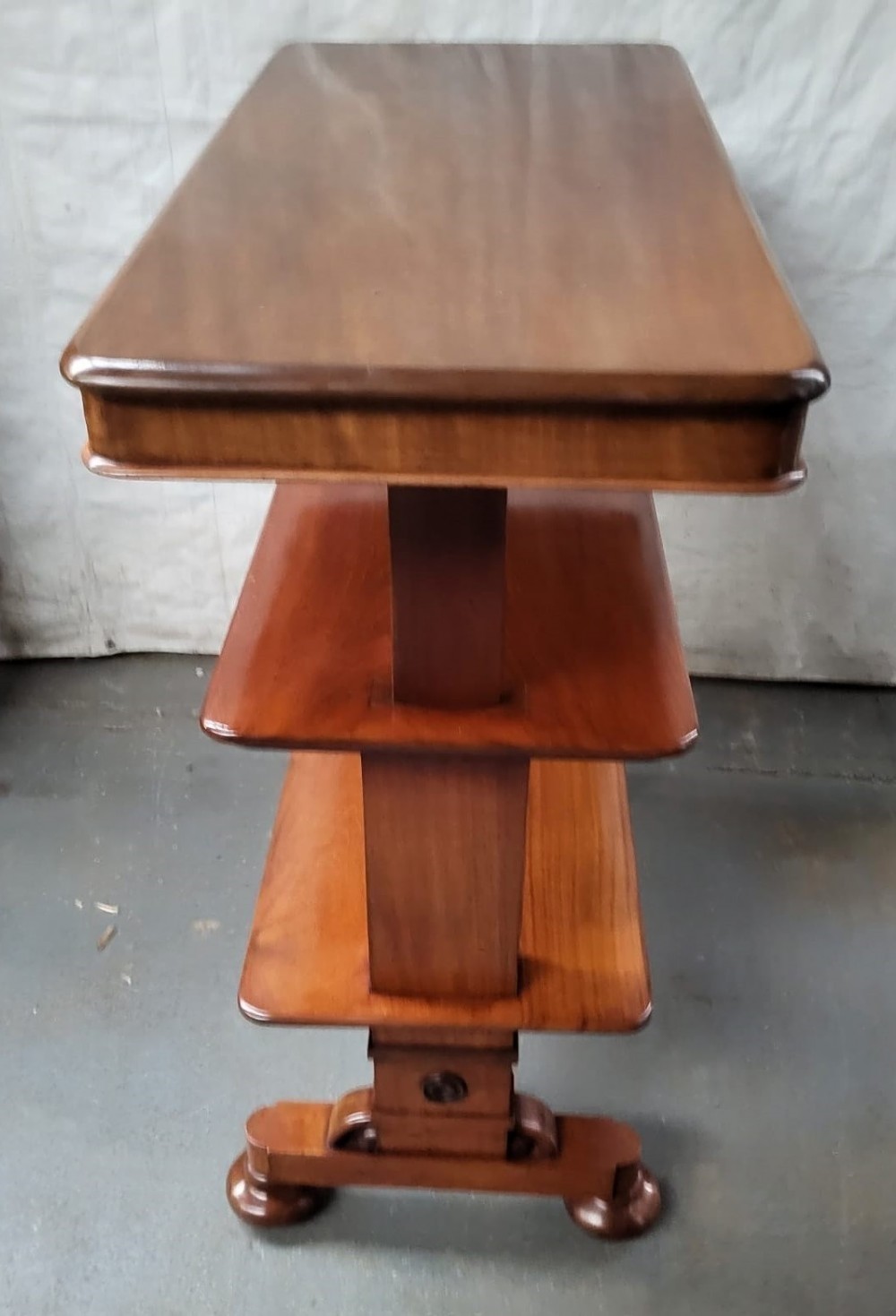 A three-tiered William IV mahogany metamorphic buffet featuring rectangular polished shelves, vertical supports, and a sturdy moulded base with turned feet. View III