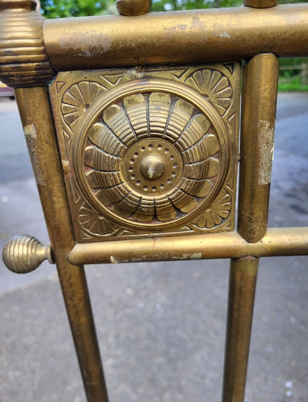A Victorian Aesthetic Movement king size brass bedstead featuring vertical spindles, geometric corner panels with roundels, and turned posts. View III
