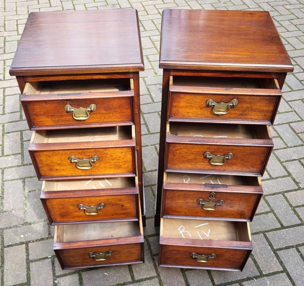 A matching pair of narrow Victorian mahogany bedside cabinets, each featuring four drawers with brass bail handles and a plinth base. View II
