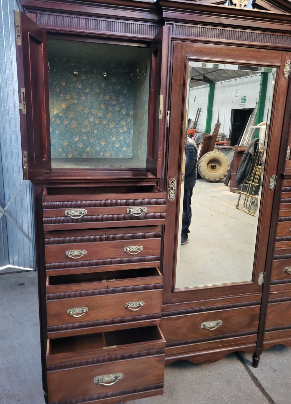 An Edwardian walnut bedroom suite comprising a breakfront compactum wardrobe with a central mirrored door alongside a matching dressing table with drawers and a swivel mirror. View IV