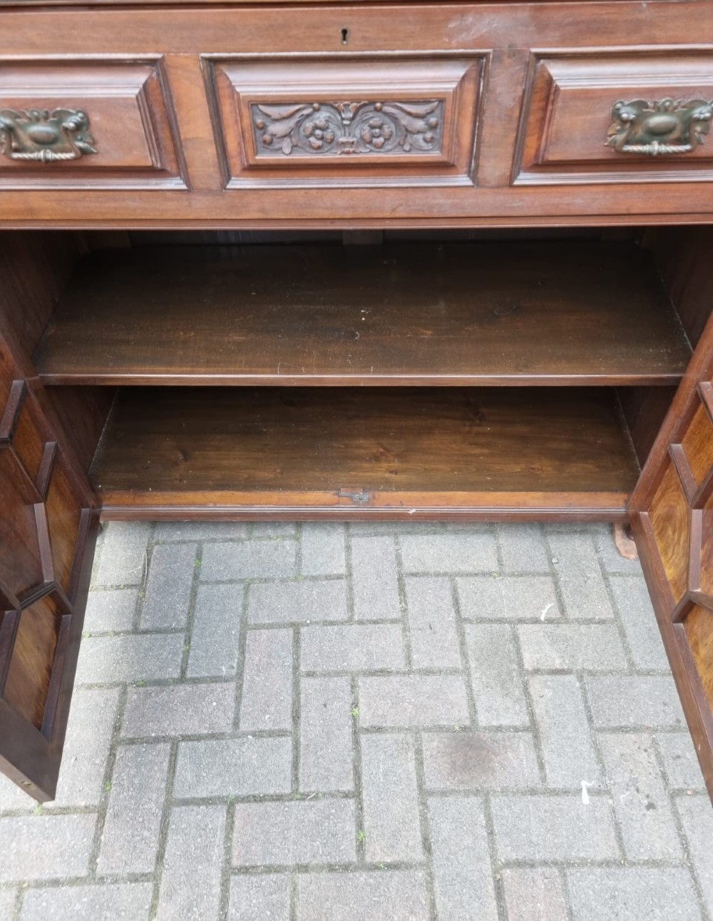 An Edwardian mahogany secretaire bookcase featuring geometric leaded glazed upper doors, metal corner brackets, and carved diamond-panelled lower cupboard doors. View III