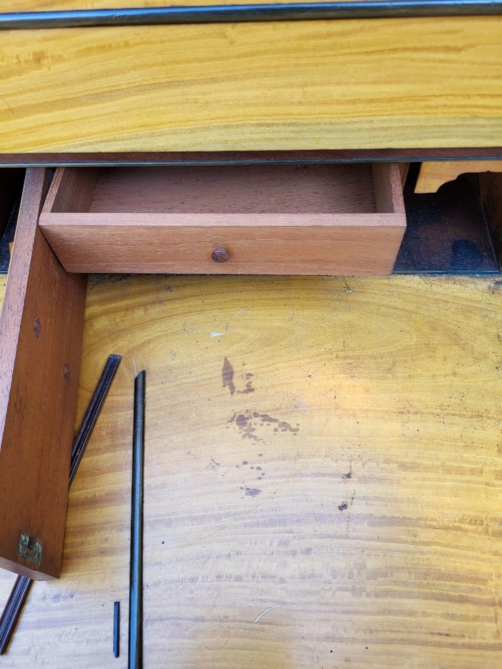 A Victorian mahogany Davenport desk featuring an inclined leather-inset writing surface, carved curved front supports, and a top gallery with glass inkwells. View VII