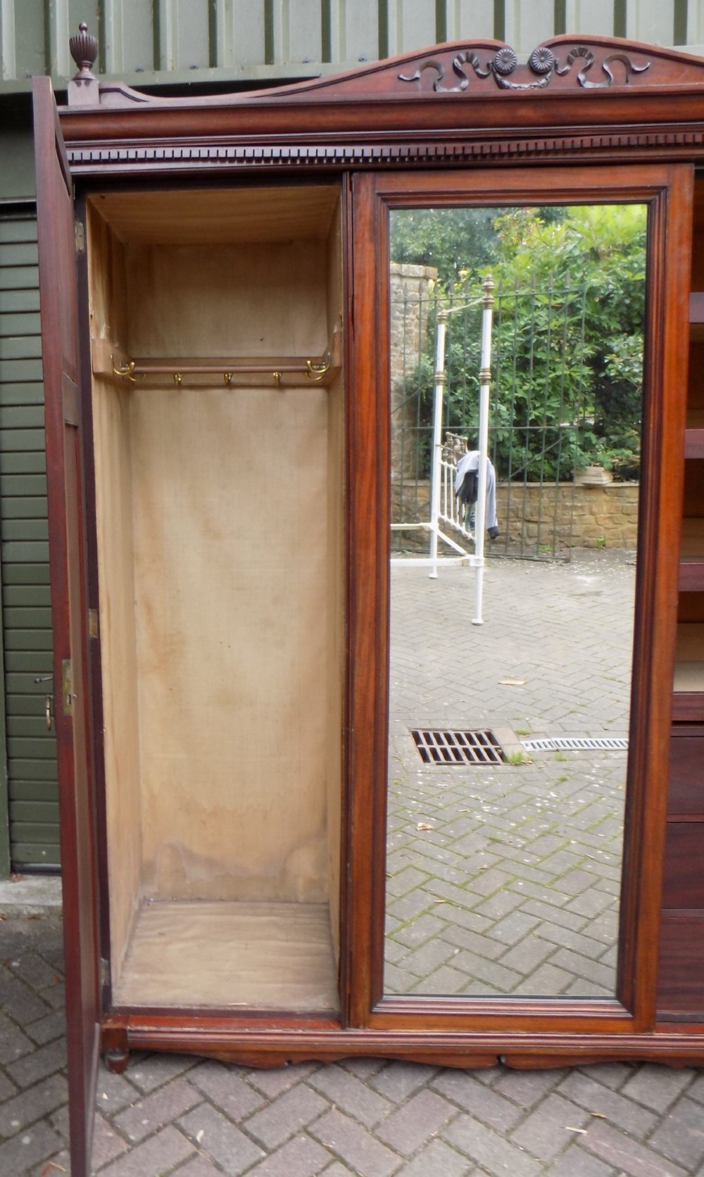 A late Victorian mahogany triple door wardrobe featuring a central full-length mirror, carved diamond relief panels, and a carved crest pediment. View III