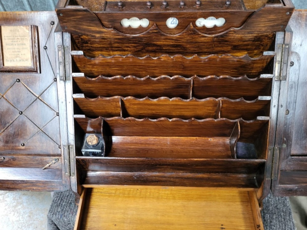 A slanted Victorian oak desk box with double doors and a central brass keyhole escutcheon. View III