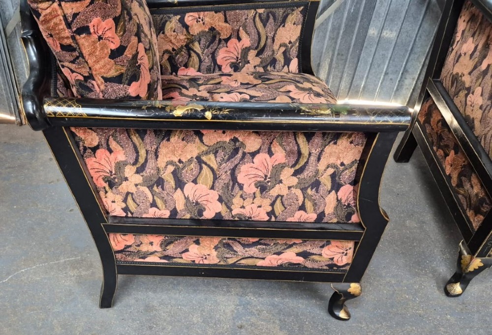 A three-piece Edwardian seating suite comprising a central two-seater settee and two matching armchairs with black lacquered frames adorned with gilded Chinoiserie patterns and pink floral pattern fabric upholstery. View III