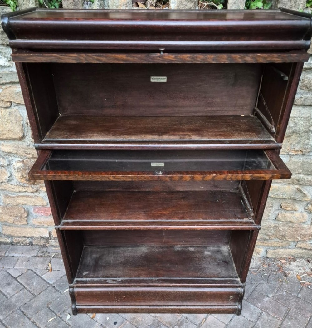 A dark oak three-tier Globe Wernicke sectional bookcase featuring glazed up-and-over doors. View II