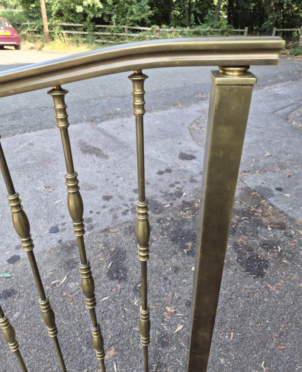 A pair of late Victorian brass single bedsteads featuring vertical spindles with turned detailing and curved top rails. View III