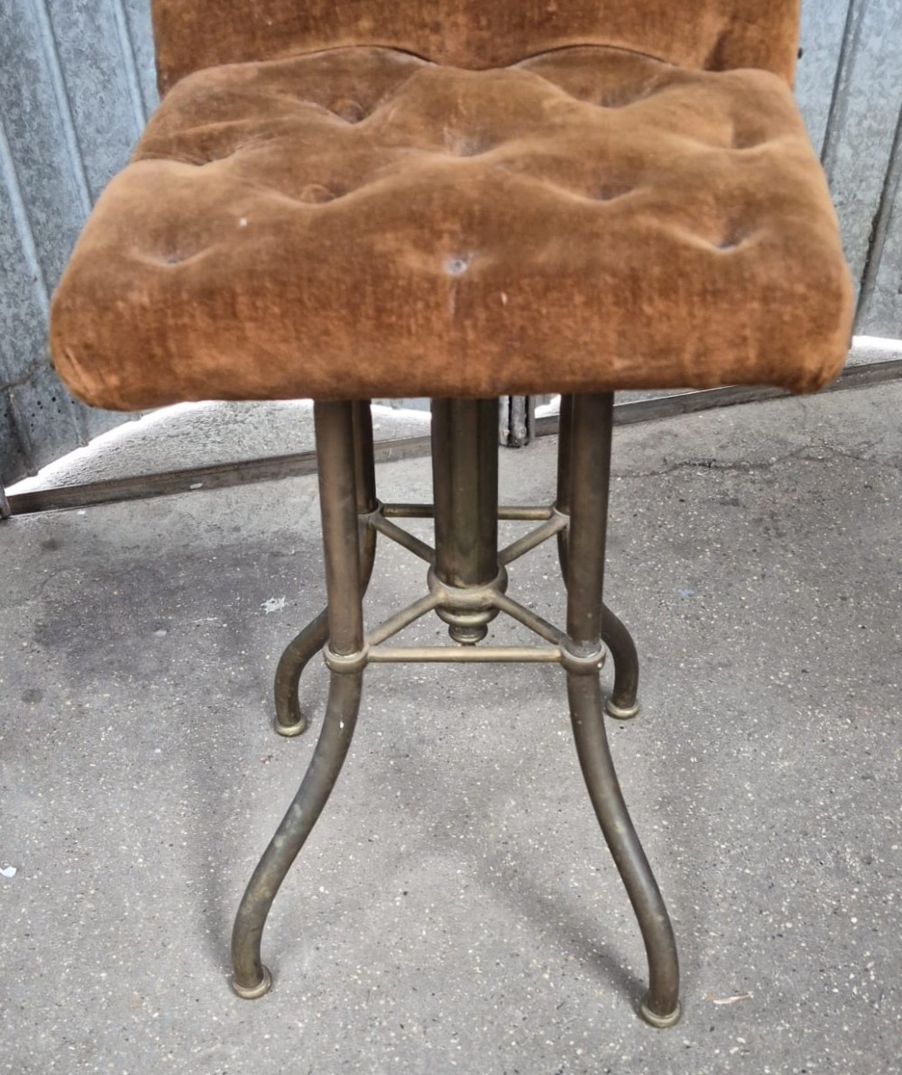 A Victorian brass-framed harpist stool with a buttoned warm brown velvet seat and splayed legs. View III