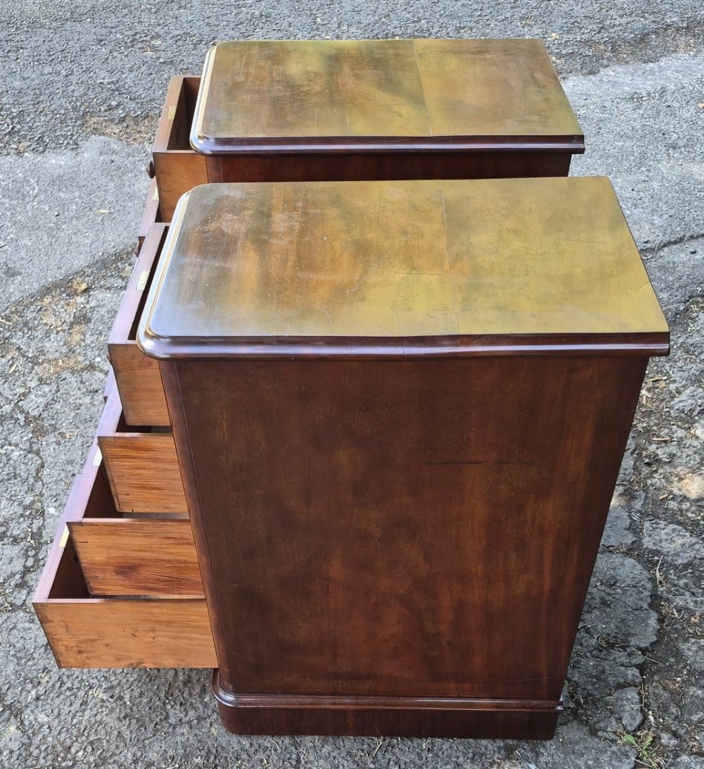 A pair of Victorian mahogany bedside chests featuring four drawers each with turned wooden knobs and a solid plinth base. View III
