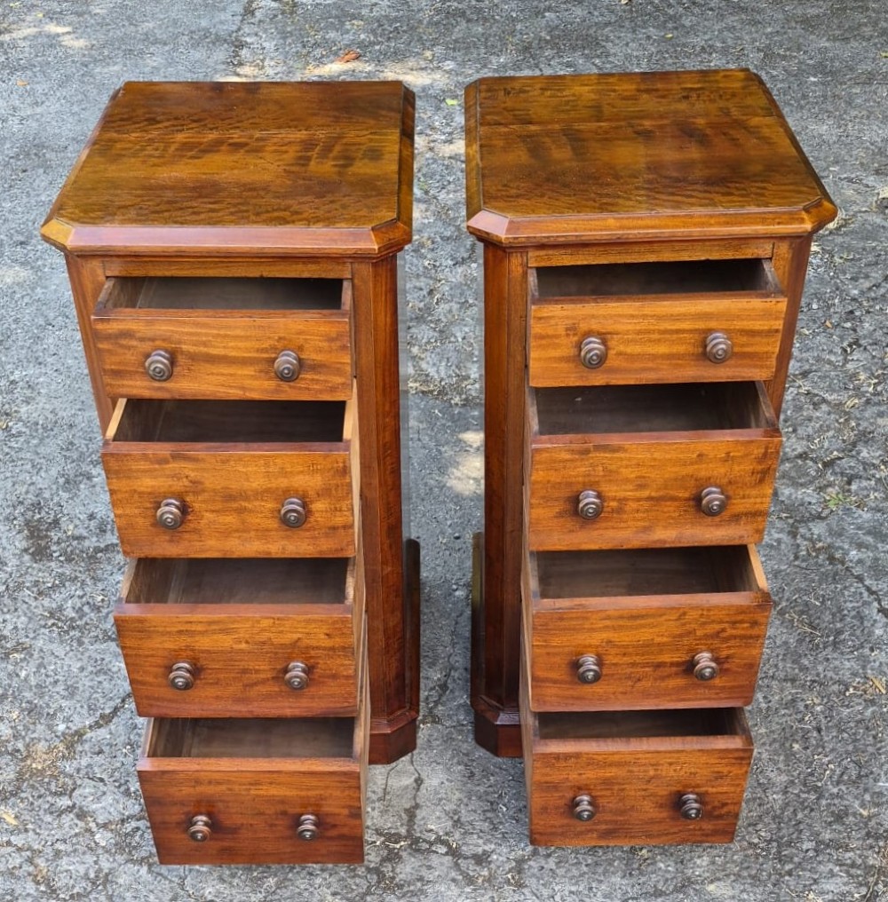 A pair of matching tall Victorian mahogany bedside chests featuring four drawers with turned wooden knobs and chamfered corners. View II