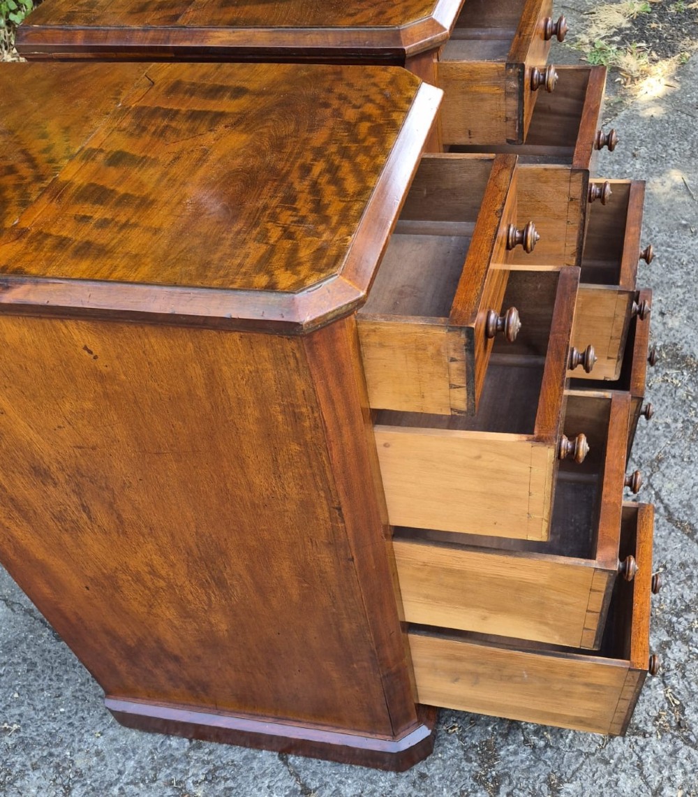 A pair of matching tall Victorian mahogany bedside chests featuring four drawers with turned wooden knobs and chamfered corners. View IV