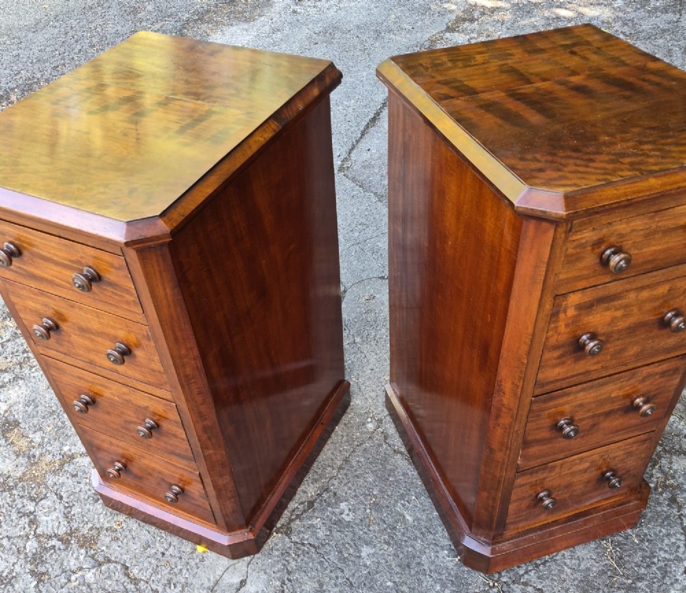 A pair of matching tall Victorian mahogany bedside chests featuring four drawers with turned wooden knobs and chamfered corners. View V