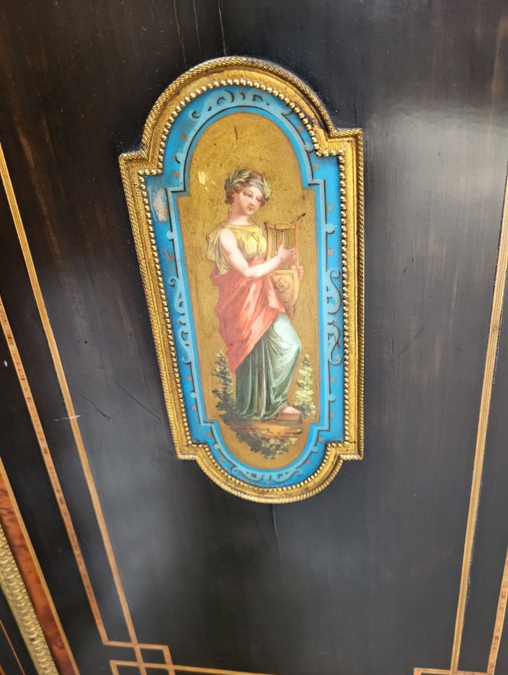 Victorian ebonised breakfront three-door side cabinet featuring gilt ormolu mounts, marquetry inlay, porcelain plaques, and a central glazed display section. View VII