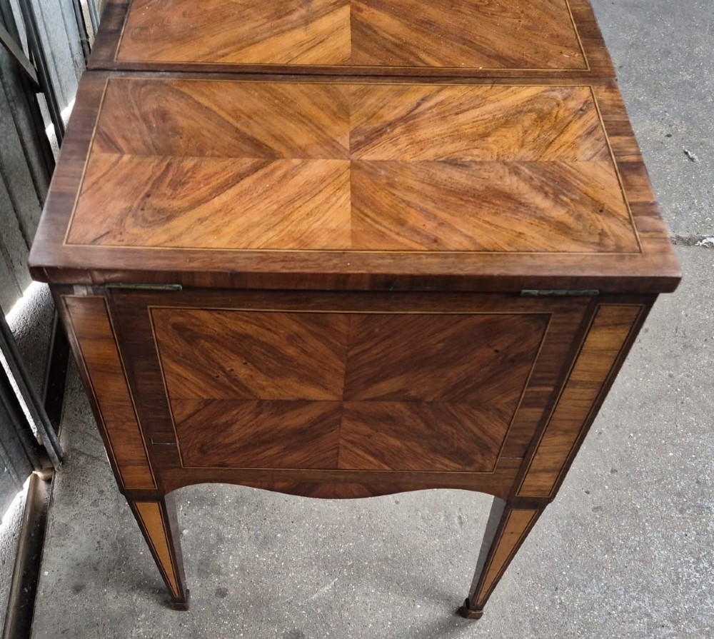A 19th-century French inlaid kingwood and walnut poudreuse with a three-part geometric parquetry top, shaped kneehole apron, brass mounts, and tapered square legs. View III