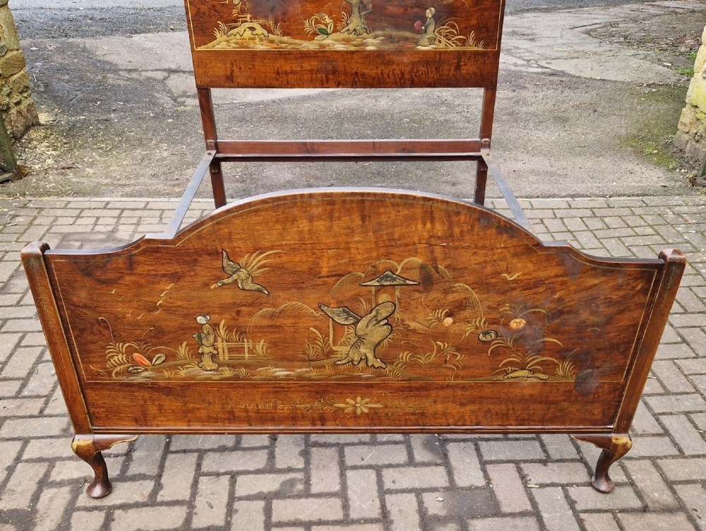 A four-piece Edwardian walnut bedroom suite featuring hand-painted Chinoiserie motifs, comprising a bedstead, wardrobe, dressing table, and chest of drawers with cabriole legs. View IV
