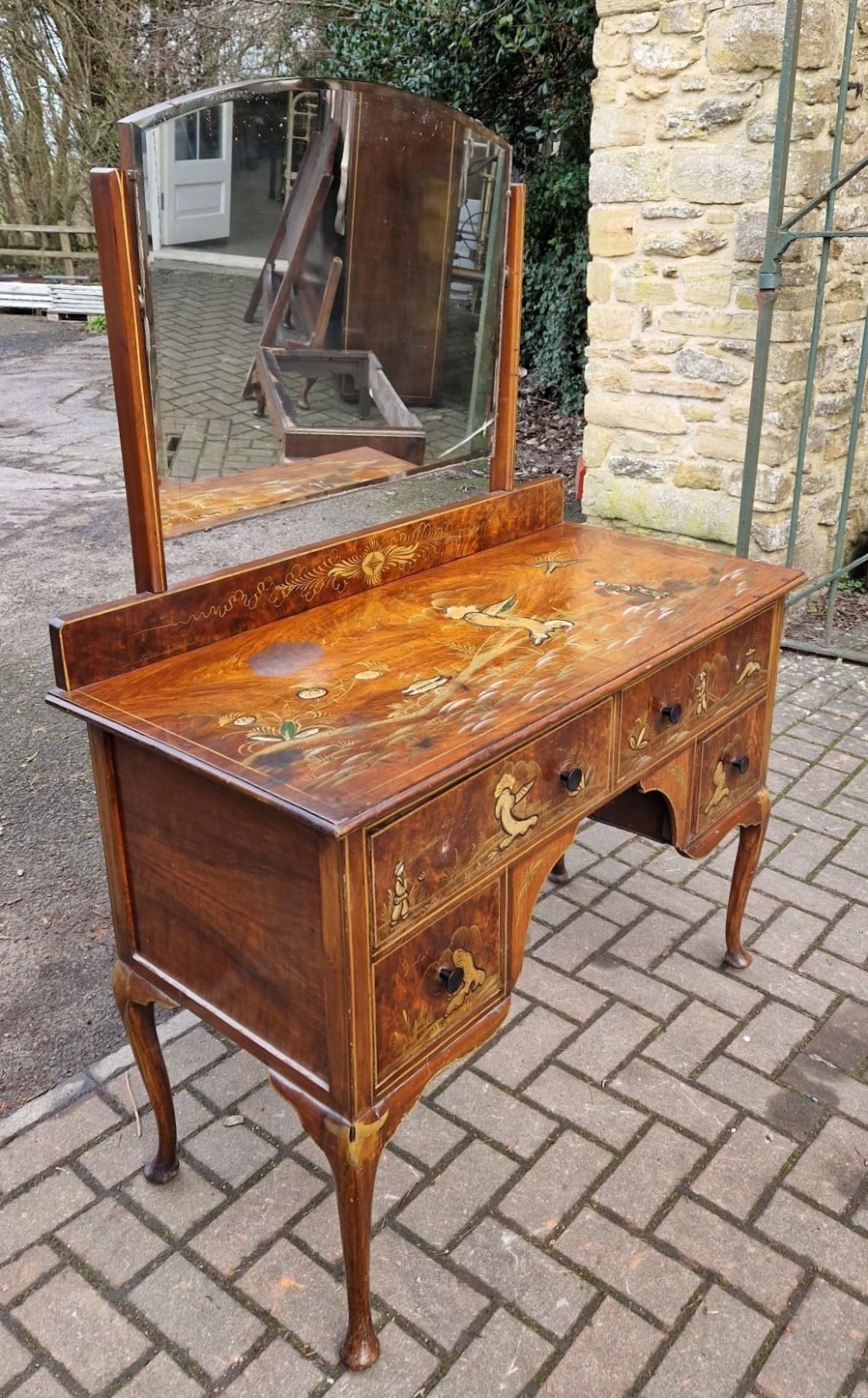 A four-piece Edwardian walnut bedroom suite featuring hand-painted Chinoiserie motifs, comprising a bedstead, wardrobe, dressing table, and chest of drawers with cabriole legs. View VI